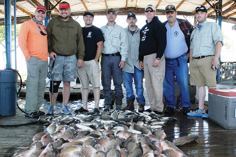 eight men with their caught fish